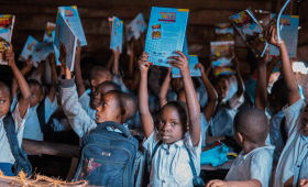 Ecotourism in Virunga National Park, student with books