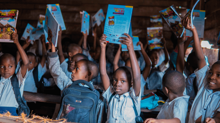 Ecotourism in Virunga National Park, student with books